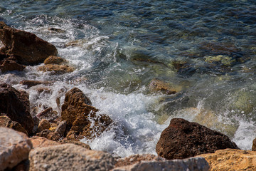 Spring beautiful day by the sea on the rocky seashore of the southern suburbs of Athens, Greece.