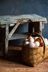 fresh organic village eggs on wooden table, healthy food,  village food. black pan with fried egg. small bench background