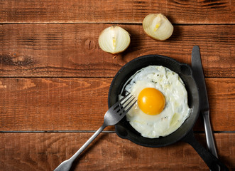 fresh organic village eggs on wooden table, healthy food,  village food. black pan with fried egg. fresh onion
