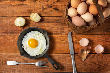 fresh organic village eggs on wooden table, healthy food,  village food. black pan with fried egg. small bench background