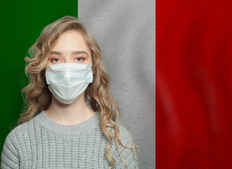 Young woman wearing a face mask with  italian national flag. Flu epidemic and virus protection...