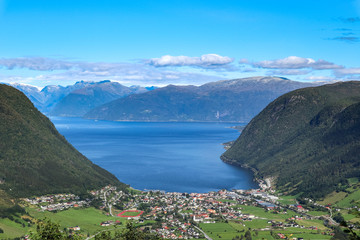 Fototapeta na wymiar Sognefjord coast wide clear aerial blue view on Vikoyri town, Norway biggest fjord. Beautiful bay, aerial summer scenery. Travel natural destinations
