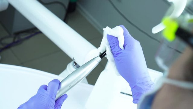 Disinfection of photopolymerization lamp in the dental office. Hygiene in dentistry. Cleaning a medical instrument.