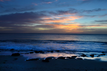 Sunrise or sunset at the beach with a colorful scky 