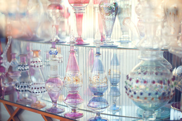 Fototapeta premium A lot of beautiful empty arabic style glass bottles for perfume in the shop behind the glass