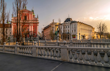 Fototapeta na wymiar Triple bridges and Franciscan church, lit by morning light, Ljubljana, Slovenia