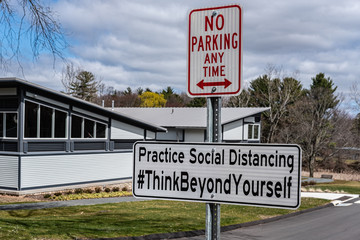 Fototapeta premium Social Distancing Sign in a Public Park in the Springtime because of Covid-19