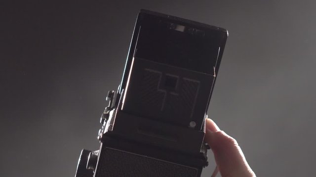 old camera on dark background - load the shutter and take photographs with a vintage camera