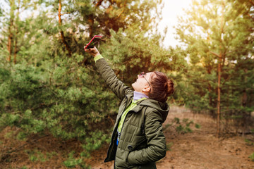 young girl in the forest makes selfie on the phone. outdoor recreation concept
