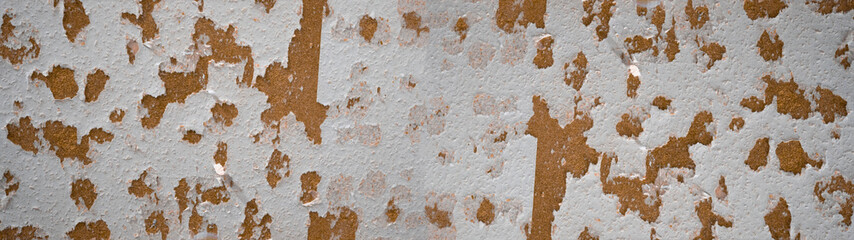 Old abstract rustic scratched torn damaged wallpaper with brown background banner panorama