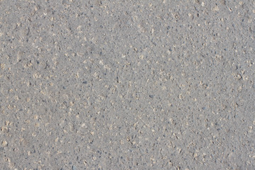 Texture of gray asphalt with dust and stones