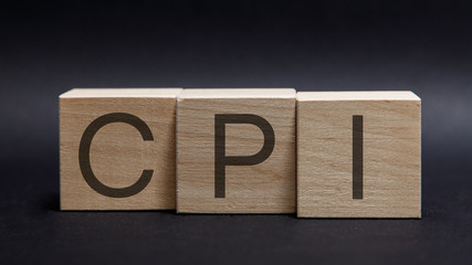 Wooden alphabets building the word CPI - Consumer Price Index acronym on blackboard