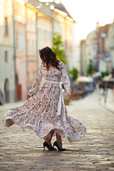 beautiful girl on a field of flowers in a beautiful dress