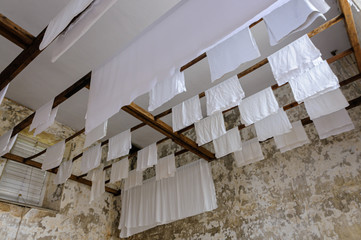 Laundry drying on wooden rails at a laundry room of a traditional stately home