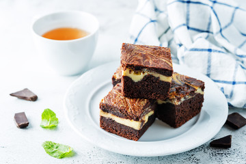 Cream cheese chocolate brownie with mint leaves