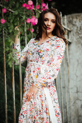 Beautiful girl walking on the street in spring. Young woman enjoying spring weather weather.