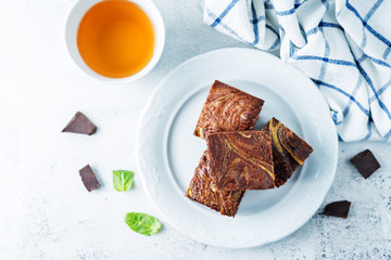 Cream cheese chocolate brownie with mint leaves