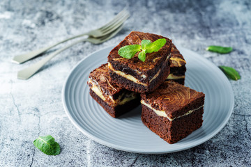 Cream cheese chocolate brownie with mint leaves