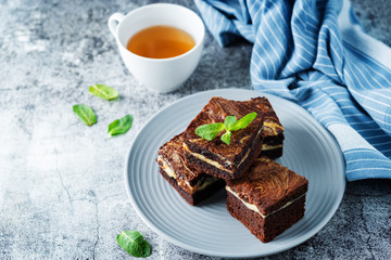 Cream cheese chocolate brownie with mint leaves