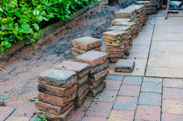 Patio bricks lifted to allow a repair