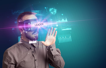 Businessman looking through Virtual Reality glasses with LEADER inscription, new business concept