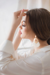 Portrait of beautiful young woman with makeup in fashion white clothes