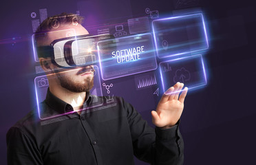 Businessman looking through Virtual Reality glasses with SOFTWARE UPDATE inscription, new technology concept