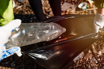 plastic bottle collect garbage into a bag. environmental cleaning