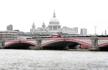 Fototapeta na wymiar Red British Bus on Blackfriars Bridge with St Paul's Cathedral and London Skyline, UK