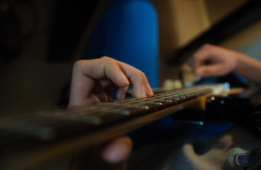 Male hands playing electric solo guitar with closeup photo. Learning musical instrument, music shop or school, blues bar or rock cafe, having fun enjoying hobby concept