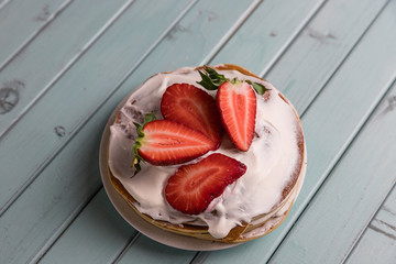 Pancake pie with strawberries. Dessert with cream and berries. National cuisine. Sweet pastries on...