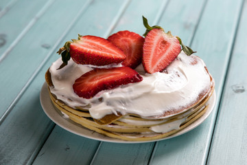 Pancake pie with strawberries. Dessert with cream and berries. National cuisine. Sweet pastries on...