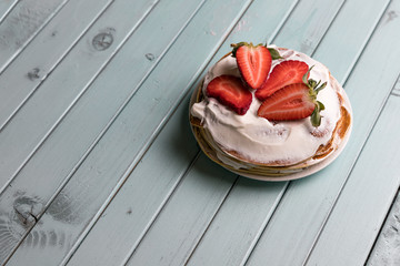 Pancake pie with strawberries. Dessert with cream and berries. National cuisine. Sweet pastries on...