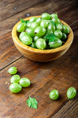 gooseberries in a plate on a wooden background