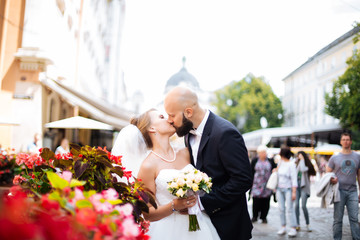 gorgeous wedding couple enjoys a Sunny day in the old town with architecture