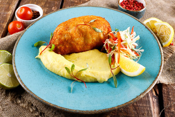 meat cutlet served with kortofel mashed potatoes and vegetables