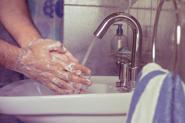 Man washing his hands with soap and water - vintage - fingers