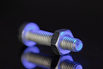  macro photograph of a small screw with a nut
