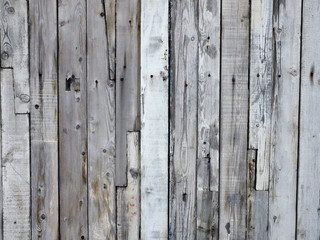 Background of an old wooden fence. Texture background of an old wooden fence