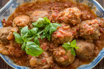Breaded meat dumplings with tomato basil sauce and baked potatoes