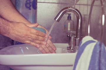 Man washing his hands with soap and water - vintage