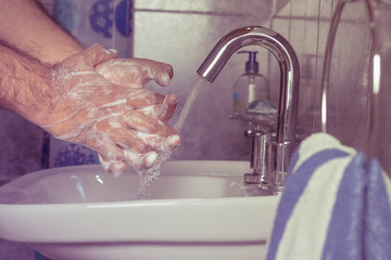 Man washing his hands with soap and water - vintage - foam