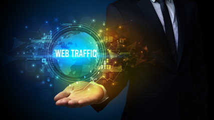 Elegant hand holding WEB TRAFFIC inscription, digital technology concept