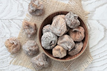 background of dried figs on a plate on wooden table