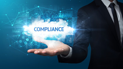 Hand of Businessman holding COMPLIANCE inscription, successful business concept