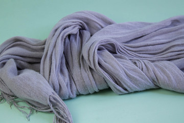 Silver scarf on a turquoise background