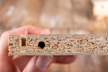 Chipboard with a milled groove. Hole in the furniture board.
