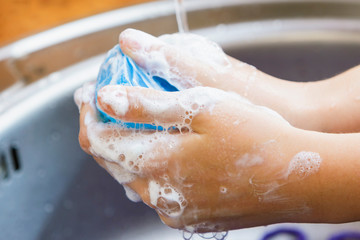 Fototapeta premium Water flows on children's hands