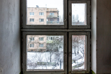 Inside corridor in old Soviet apartment building in Rivne, Ukraine in winter with nobody in run-down closed window interior of floor