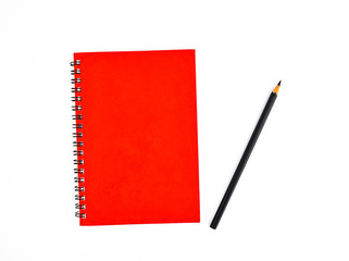 Black pencil beside a red color covered single note paper diary isolated on a white background
